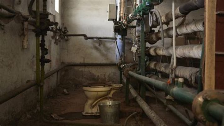 The Weird Story Behind Solitary Toilets Found In The Middle Of Basements
